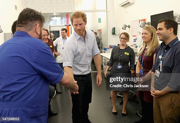 Prince Harry meets staff as visits Burrell Street Sexual Health Clinic on July 14, 2016 in London, England. Prince Harry was visiting the clinic, run...