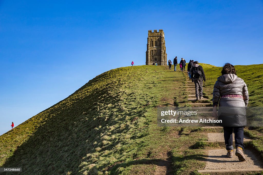 Families Use The Concrete Paths Climbing To Glastonbury Tor The families-use-the-concrete-paths-climbing-to-glastonbury-tor-the
