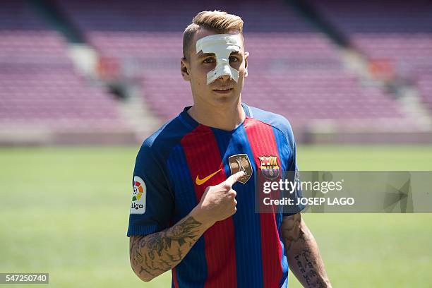 Barcelona's new player French defender Lucas Digne poses during his official presentation at the Camp Nou stadium in Barcelona, after signing his new...