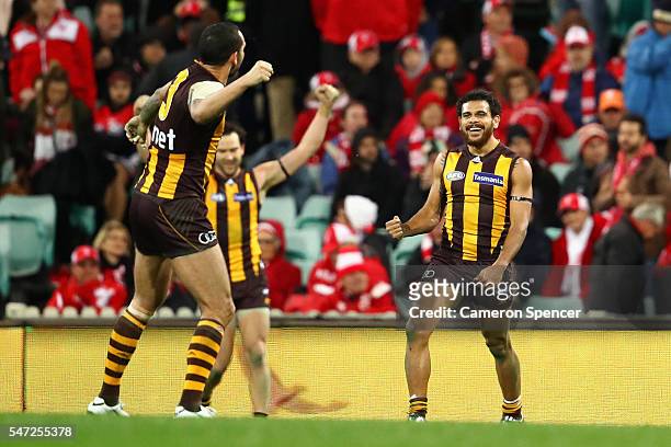 Cyril Rioli of the Hawks celebrates with team mates after winning the round 17 AFL match between the Sydney Swans and the Hawthorn Hawks at Sydney...
