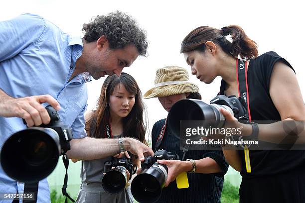 Getty Images photographer Adam Pretty teaches participants how to take photographs during his track and field class for children 'Tamesue College...