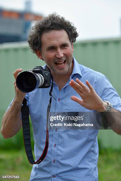 Getty Images photographer Adam Pretty talks during his track and field class for children 'Tamesue College Running Club' at Toyosu MAGIC BEACH on...