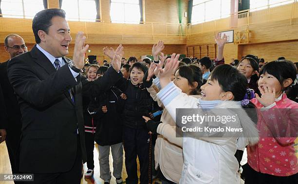 Shichigahama, Japan - Turkish Deputy Prime Minister Ali Babacan on Dec. 7 meets with students at an elementary school in the Miyagi Prefecture town...