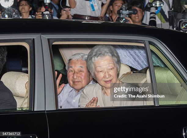 Emperor Akihito and Empress Michiko wave to well-wishers on arrival at the Imperial Palace on July 14, 2016 in Tokyo, Japan. The emperor met 270 VIPs...