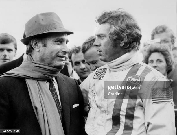 Former Argentine race driver Juan Manuel Fangio talks with American actor Steve McQueen on October 02, 1970 during the filming of the film "Le Mans",...