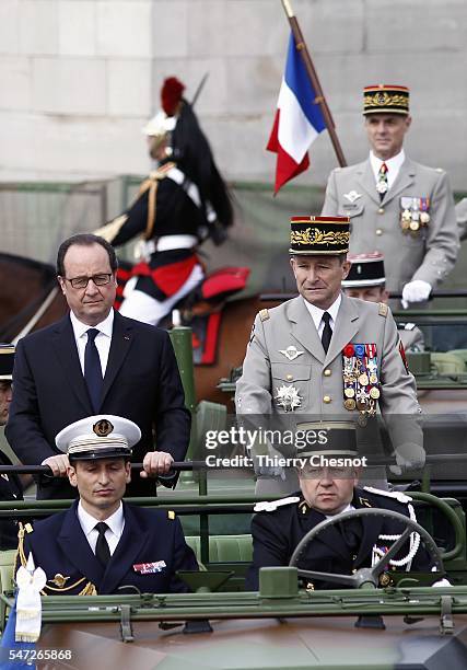 French President Francois Hollande and the Chief of the Defence Staff French army General Pierre de Villiers arrive in a command car for the annual...