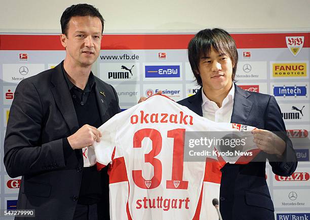 Germany - Japanese striker Shinji Okazaki shows his new jersey at a press conference in Stuttgart, Germany, on Jan. 30 as his move to German...