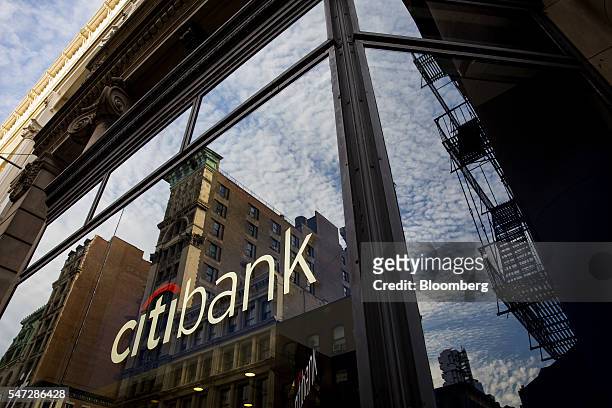 Citigroup Inc. Bank signage is reflected on a branch window in New York, U.S., on Tuesday, July 12, 2016. Citigroup Inc. Is scheduled to report...