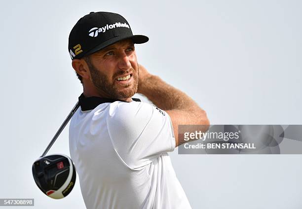 Golfer Dustin Johnson watches his drive from the 13th tee during his first round on the opening day of the 2016 British Open Golf Championship at...