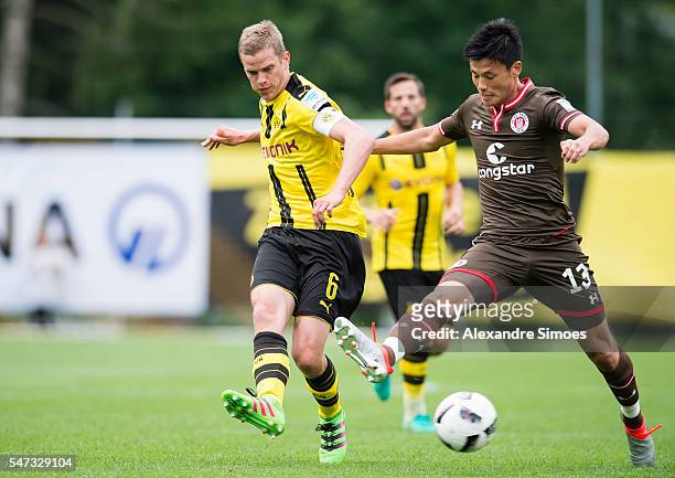 Ryo Miyaichi of FC St. Pauli challenges Sven Bender of Borussia Dortmund during Borussia Dortmund v FC St. Pauli - Preseason Friendly on July 14,...