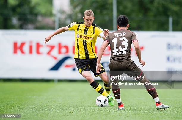 Ryo Miyaichi of FC St. Pauli challenges Sven Bender of Borussia Dortmund during Borussia Dortmund v FC St. Pauli - Preseason Friendly on July 14,...