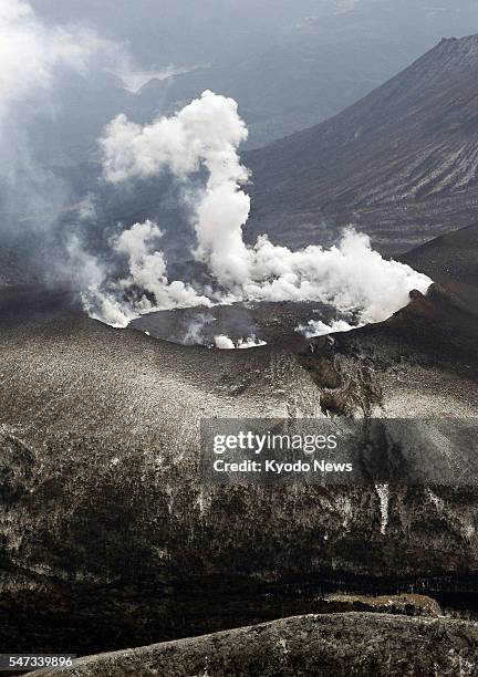 Japan - Aerial photo taken from a helicopter shows smoke emerging from Shinmoe Peak on the border of Miyazaki and Kagoshima prefectures on Feb. 13,...