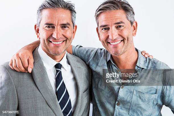 middle age twins, one smart, one casual - twin stock pictures, royalty-free photos & images