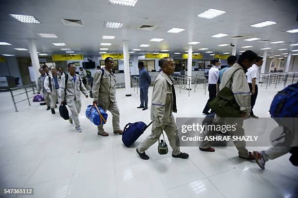 Chinese nationals leave the airport upon their arrival in the Sudanese capital Khartoum on July 14, 2016 as they were evacuated from South Sudan...