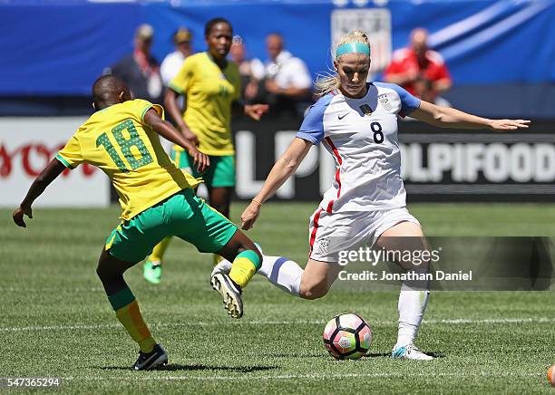 Julie Johnston of the United States shoots past Nomoumelelo Nyandeni of South Africa during a friendly match at Soldier Field on July 9, 2016 in...