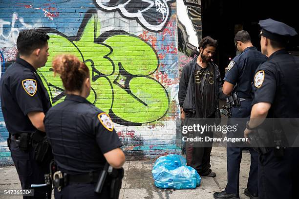 New York City police officers stop a man for suspected K2 possession, July 14, 2016 on the border of the Bedford-Stuyvesant and Bushwick...