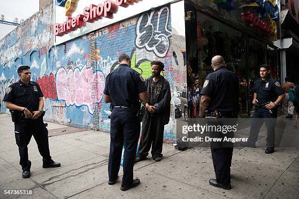 New York City police officers stop a man for suspected K2 possession, July 14, 2016 on the border of the Bedford-Stuyvesant and Bushwick...