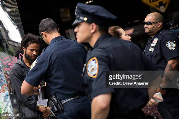 New York City police officers stop a man for suspected K2 possession, July 14, 2016 on the border of the Bedford-Stuyvesant and Bushwick...
