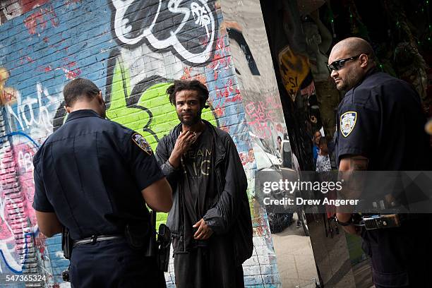 New York City police officers stop a man for suspected K2 possession, July 14, 2016 on the border of the Bedford-Stuyvesant and Bushwick...