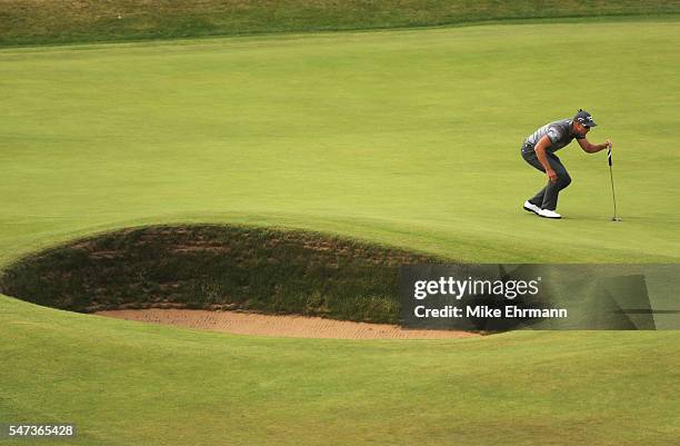 Henrik Stenson of Sweden lines up a putt on the 18th during the first round on day one of the 145th Open Championship at Royal Troon on July 14, 2016...
