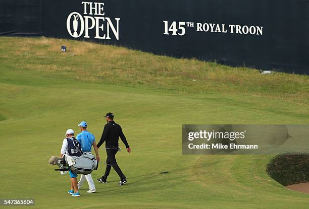 Dustin Johnson of the United States and Martin Kaymer of Germany walk up the 18th during the first round on day one of the 145th Open Championship at...