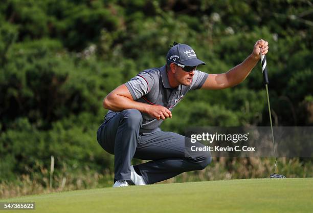 Henrik Stenson of Sweden lines up a putt on the 12th during the first round on day one of the 145th Open Championship at Royal Troon on July 14, 2016...