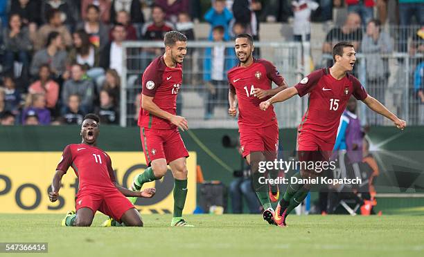 Buta of Portugal celebrates his team's fourth goal with team mates during the UEFA Under19 European Championship match between U19 Germany and u19...
