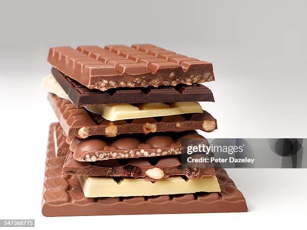 stack of chocolate bars - schockolade stock-fotos und bilder