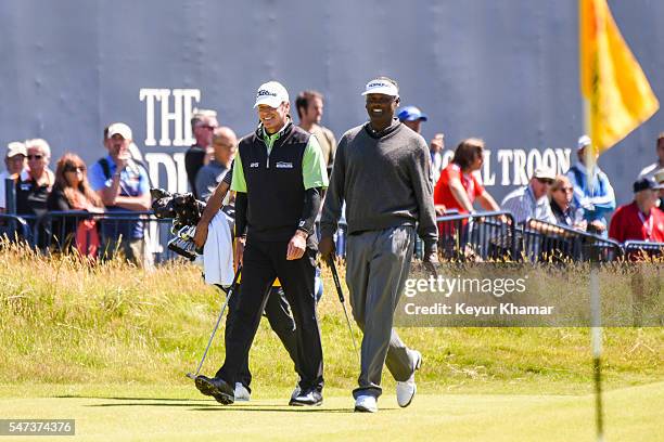 Vijay Singh of Fiji and Steve Stricker of the United States share a laugh as they walk to the 18th hole green during the first round on day one of...