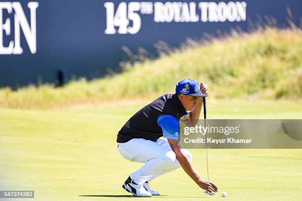 Rickie Fowler of the United States reads his putt on the 18th hole green during the first round on day one of the 145th Open Championship at Royal...