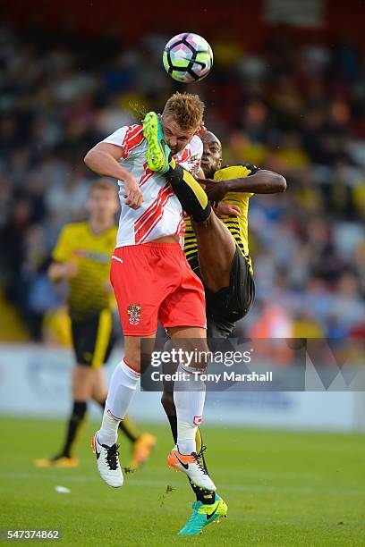 Allan Nyom of Watford tackles Matt Godden of Stevenage during the Pre-Season Friendly match between Stevenage and Watford at The Lamex Stadium on...