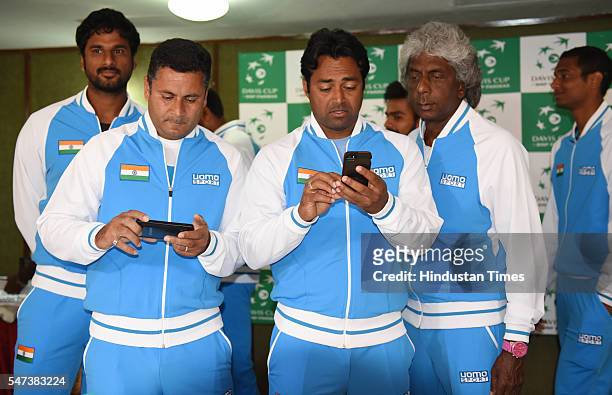 Leander Paes with Coach Zeeshan Ali and Anand Amritraj after the draw ceremony of Davis Cup between India and Korea at Haryana Raj Bhawan on July 14,...