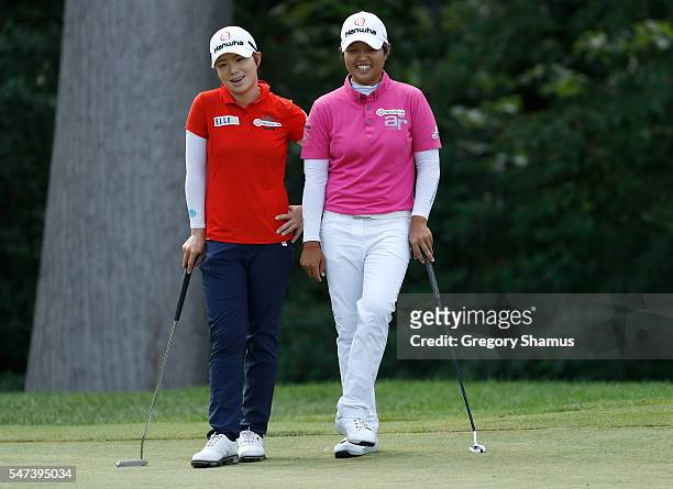 Eun-Hee Ji of South Korea and Naru Nomura of Japan talk on the sixth green during the first round of the Marathon Classic presented by Owens Corning...