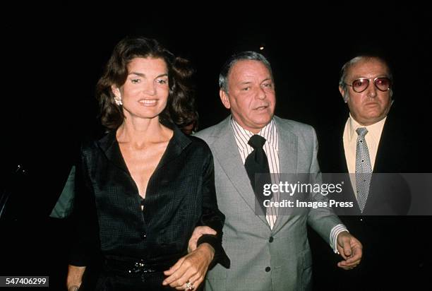 Jacqueline Kennedy Onassis, Frank Sinatra and bodyguard Jilly Rizzo arriving at the 21 Club after his concert circa 1975 in New York City.