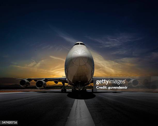 passenger plane on runway at sunset - plane front view stock pictures, royalty-free photos & images