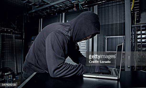 hacker operating in server rooms - terrorism concept stock pictures, royalty-free photos & images
