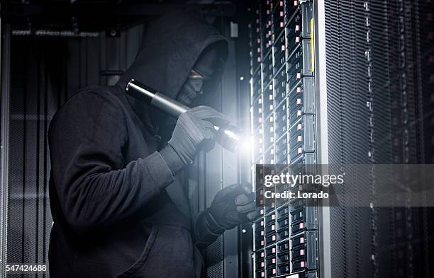 hacker operating in server rooms - store robbery stock pictures, royalty-free photos & images