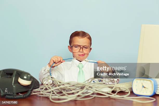 young boy it professional smiles at computer with wire - problem stock pictures, royalty-free photos & images