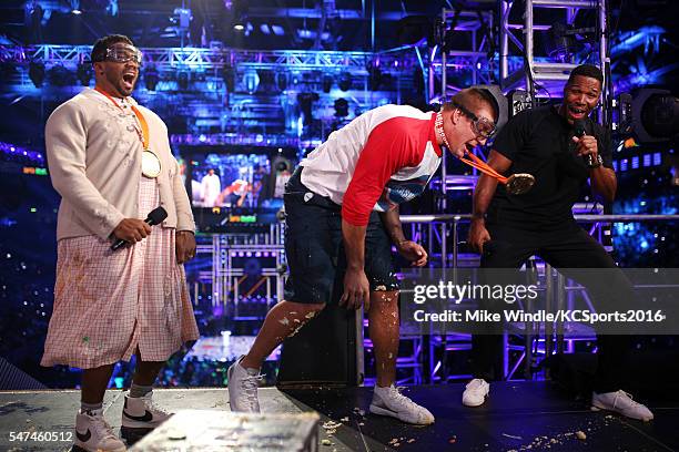 Host Russell Wilson, NFL player Rob Gronkowski, and TV personality/retired NFL player Michael Strahan speak onstage during the Nickelodeon Kids'...