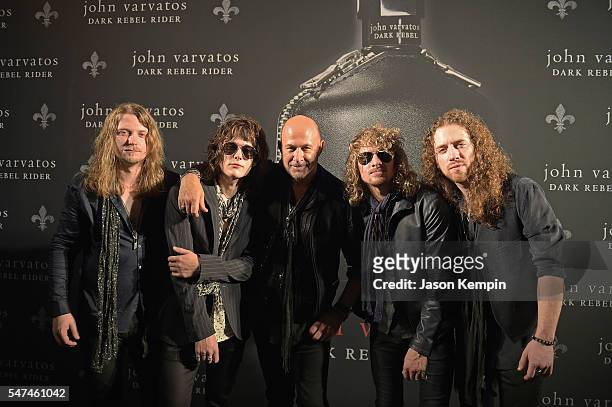 Musicians Noah Denney, Tyler Bryant, Caleb Crosby, and Graham Whitford of Tyler Bryant & The Shakedown pose with designer John Varvatos during the...