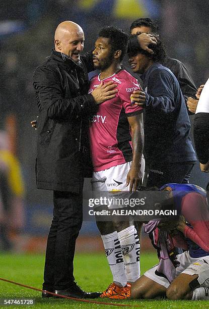 Ecuador's Independiente del Valle defender team coach Pablo Repetto embraces midfielder Jonathan Gonzales after defeating Argentina's Boca Juniors in...