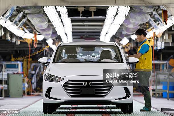 An employee performs final inspections on a Hyundai Motor Co. Elantra vehicle on the production line at the company's plant in Ulsan, South Korea, on...