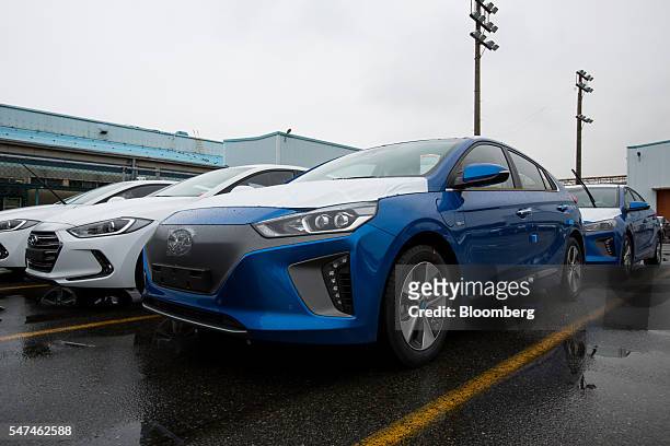 Hyundai Motor Co. Ioniq electric vehicles , right, and Elantra vehicles sit in the company's plant in Ulsan, South Korea, on Monday, July 4, 2016....