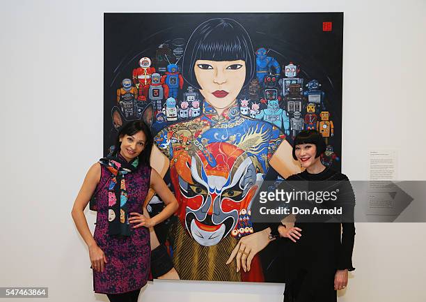 Kate Beynon and Claudia Chan Shaw pose in front of Katte Beynon's portrait of Claudia titled 'Claudia, Spartacus and the robots' at the winners...