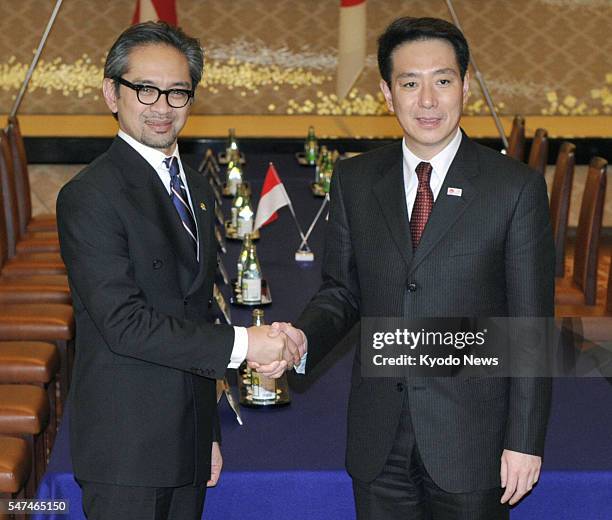 Japan - Indonesian Foreign Minister Marty Natalegawa shakes hands with Japanese Foreign Minister Seiji Maehara ahead of their talks in Tokyo on Feb....