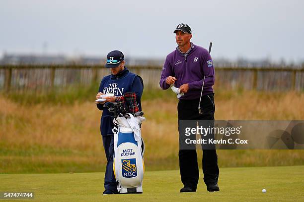 Matt Kuchar of the United States looks on next to his caddie John Wood on the 1st during the second round on day two of the 145th Open Championship...
