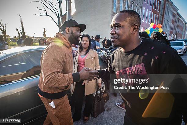 Safe Streets Violence Interrupter Lamont Medley, left, greets Darrell Savoy, right, as Paige Fitz stands by. Fitz runs a nonprofit that mentors young...