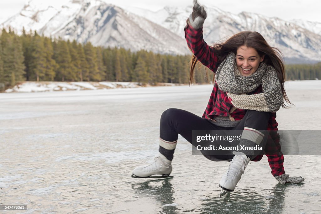 Teen girl slips while skating on mountain lake