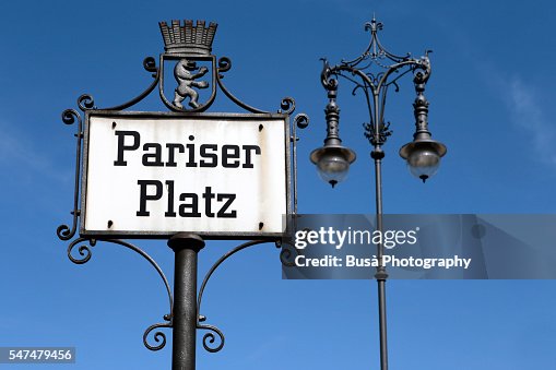 Street sign of Pariser Platz, by the Brandenburg Gate, at the end of Unter den Linden boulevard in the Mitte district of Berlin, Germany Street sign of Pariser Platz, by the Brandenburg Gate, at the end of Unter den Linden boulevard in the Mitte district of Berlin, Germany
