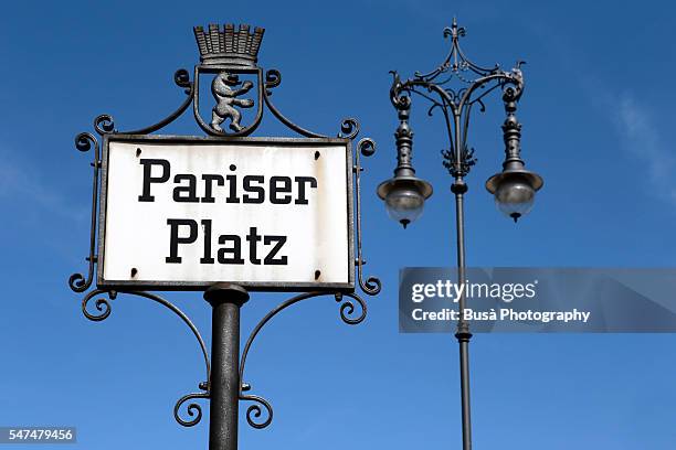 street sign of pariser platz, by the brandenburg gate, at the end of unter den linden boulevard in the mitte district of berlin, germany - pariser platz stock pictures, royalty-free photos & images